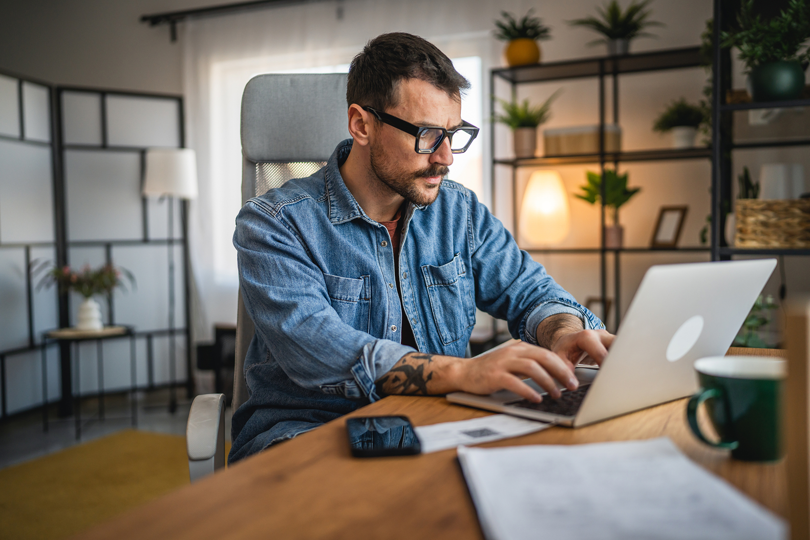 A man working on tablet device while sitting at a desk