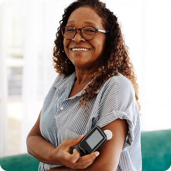 A woman holding a device on her arm