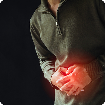 A man holding his midsection that's glowing bright red and grimacing in pain.